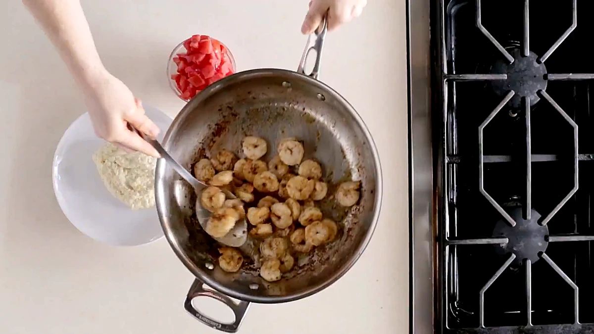 Golden garlic shrimp sauteing in a skillet