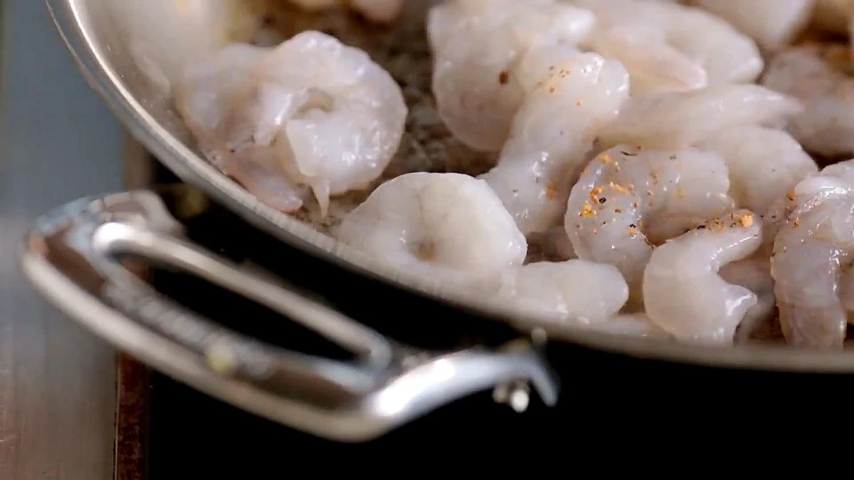 Shrimp in the skillet sprinkled with garlic and herb seasoning