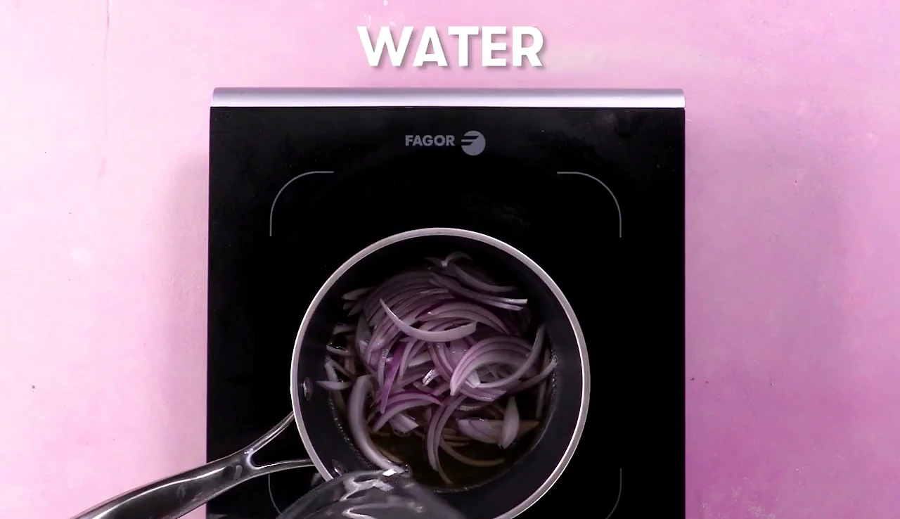Water added to red onions and vinegar