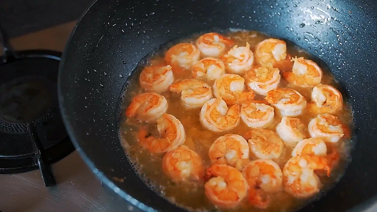 Shrimp simmering in lemon white wine sauce