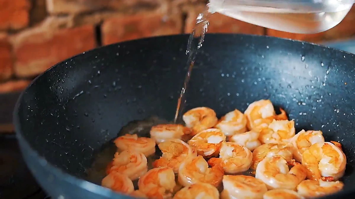 White wine poured into shrimp pan