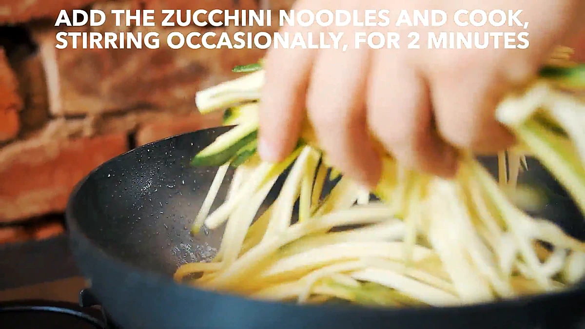 Zucchini noodles added to the pan