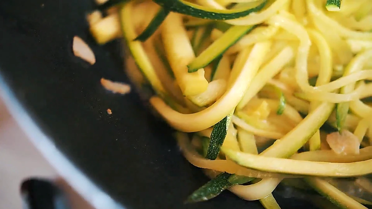 Zucchini noodles cooking in the sauce